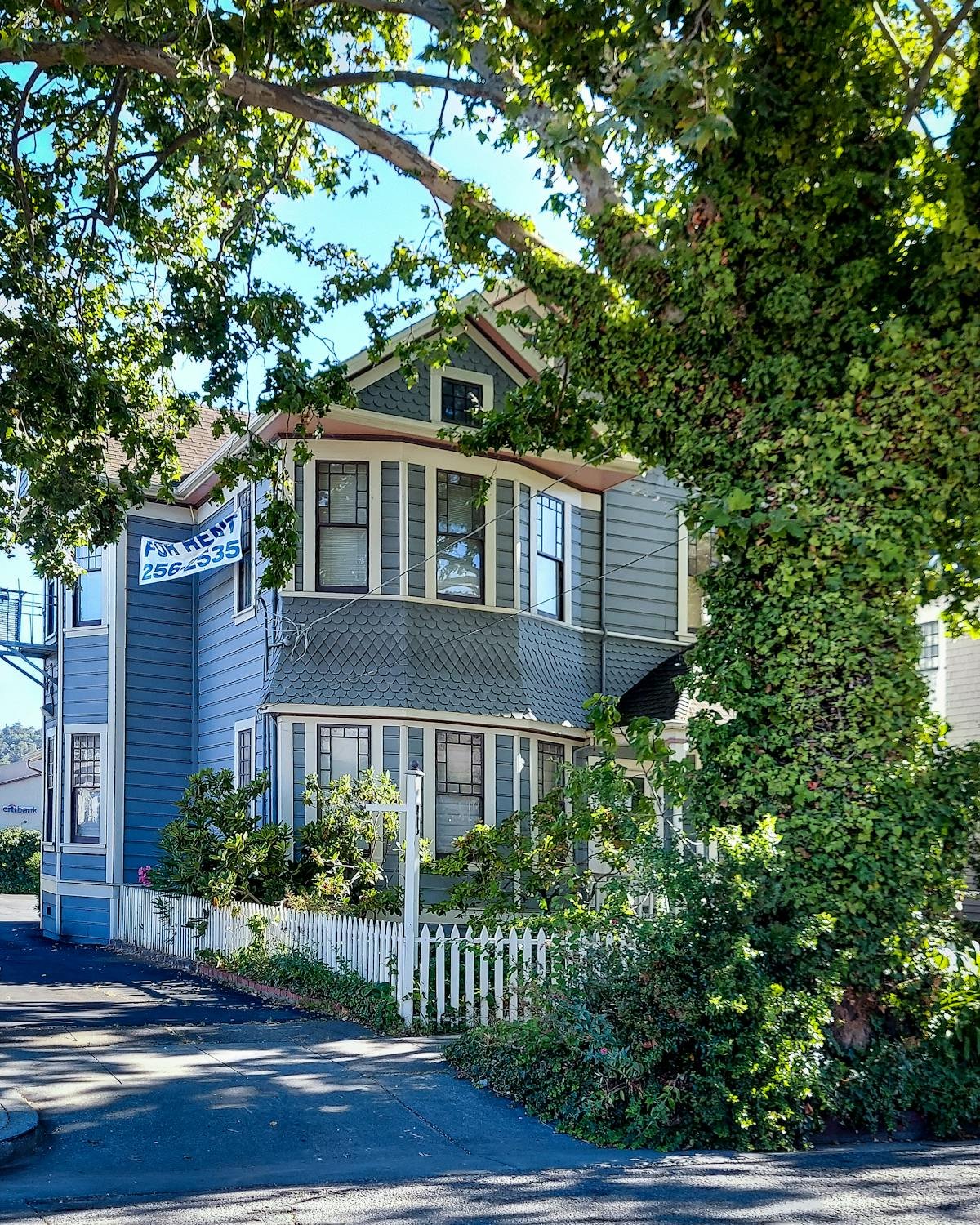 Classic house exterior with porch and greenery